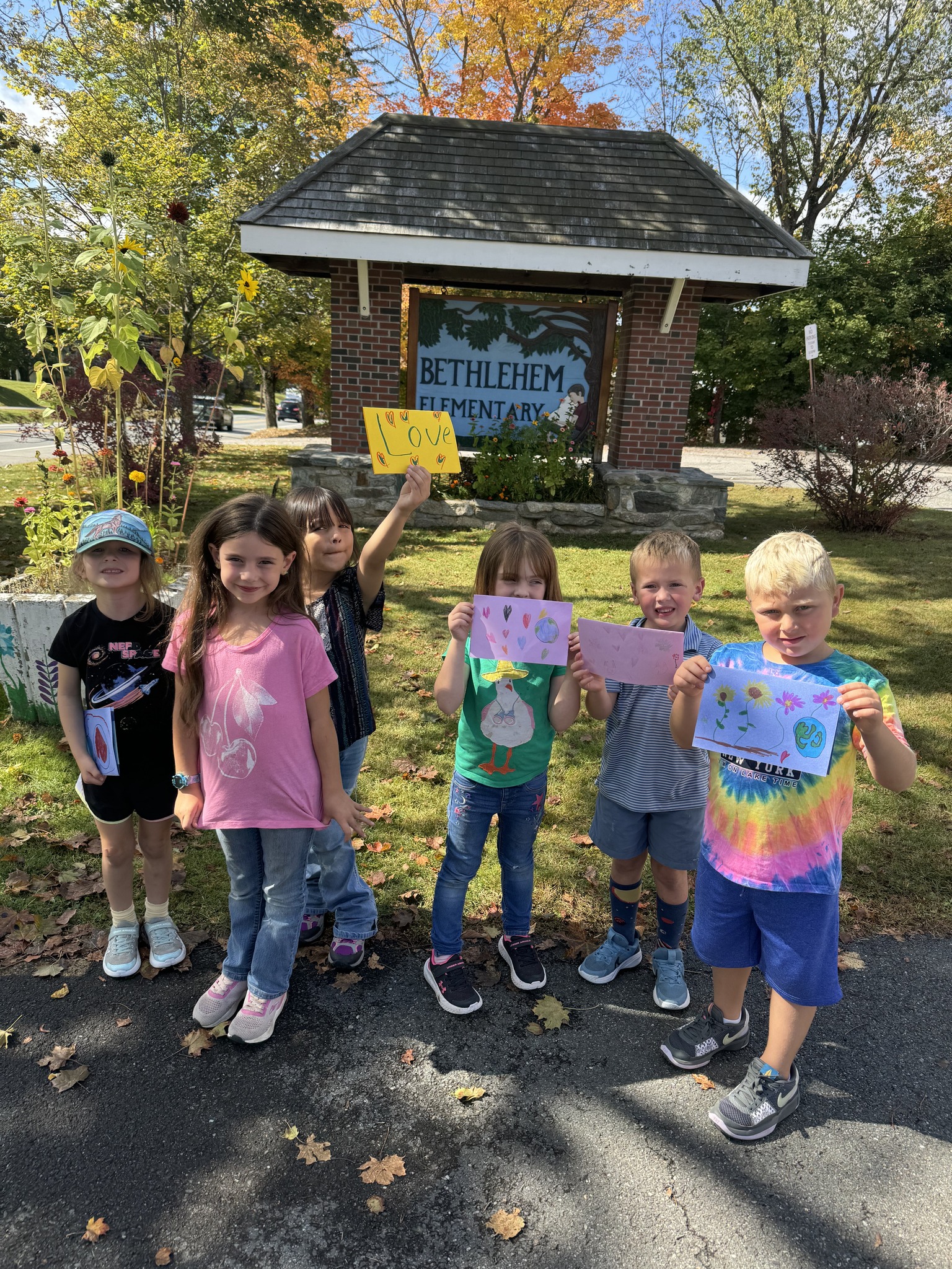 young students standing in front of the Bethlehem School Sign